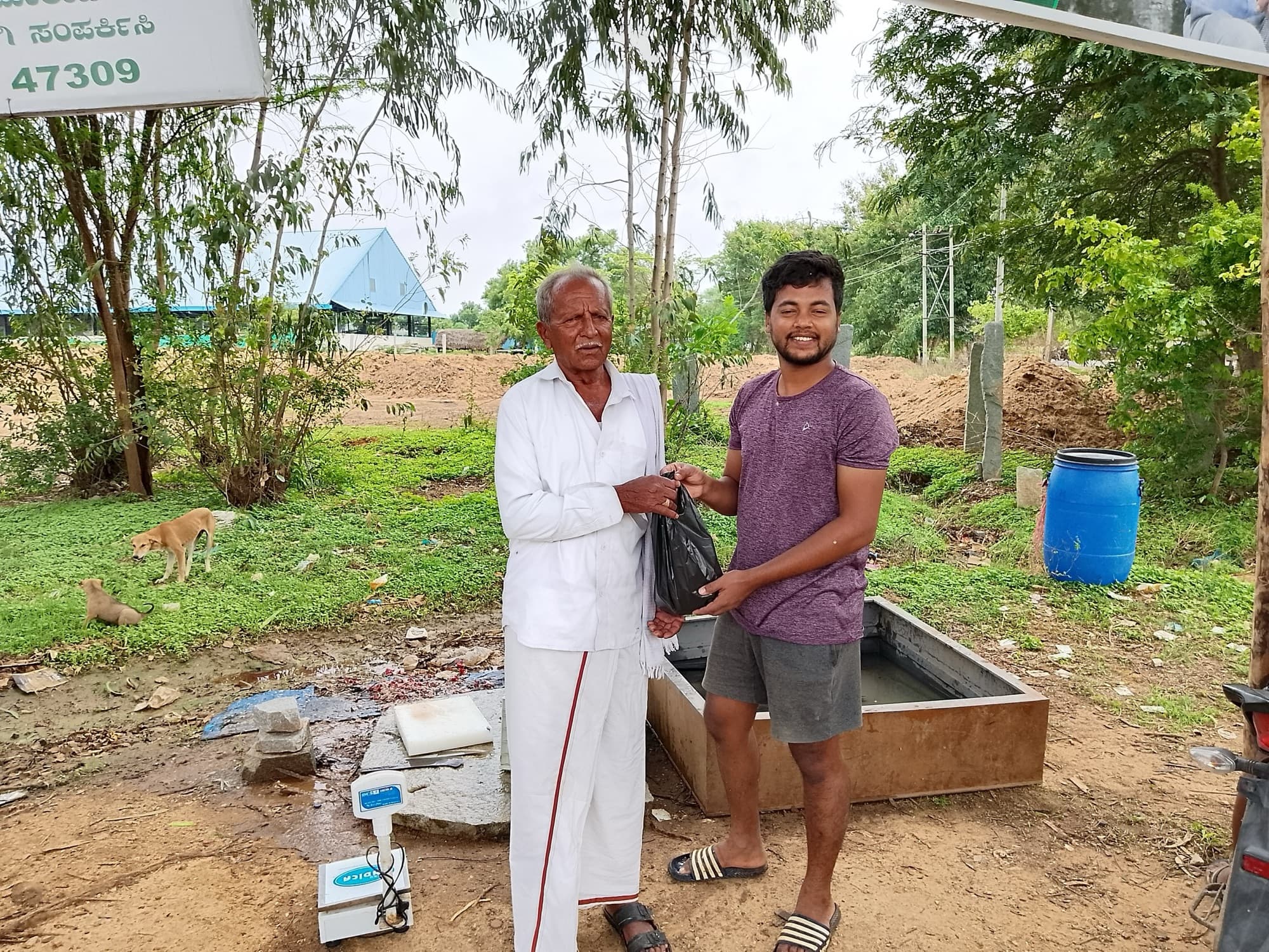 An elderly customer in white receives his bag of fresh fish with a warm smile at a HasiruAqua stall